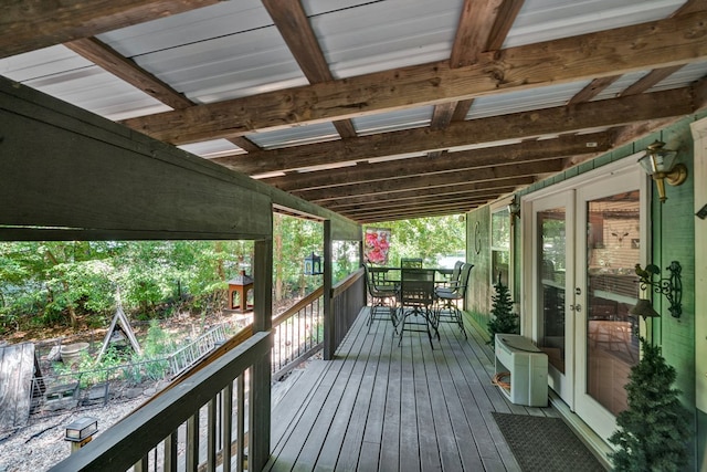 wooden deck featuring outdoor dining space and french doors