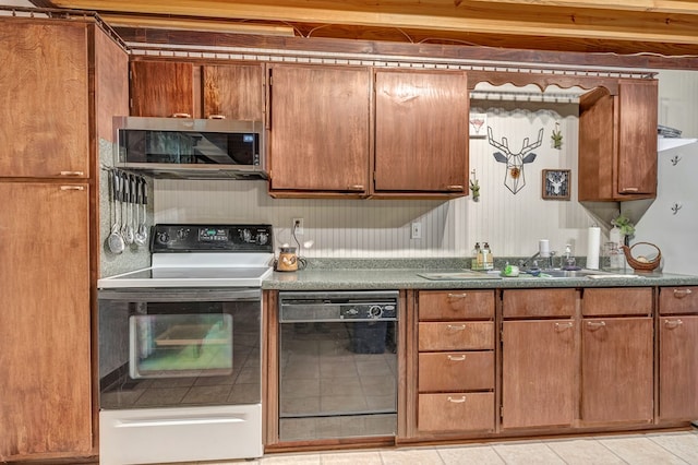 kitchen featuring black dishwasher, range with electric cooktop, brown cabinetry, and stainless steel microwave