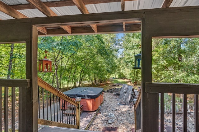 wooden deck featuring a hot tub