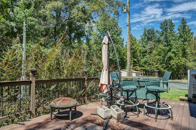 wooden deck featuring a fire pit