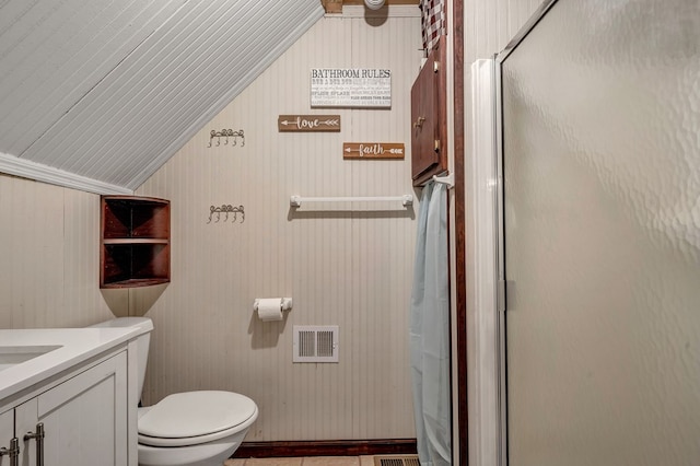 bathroom featuring visible vents, lofted ceiling, toilet, vanity, and a shower stall