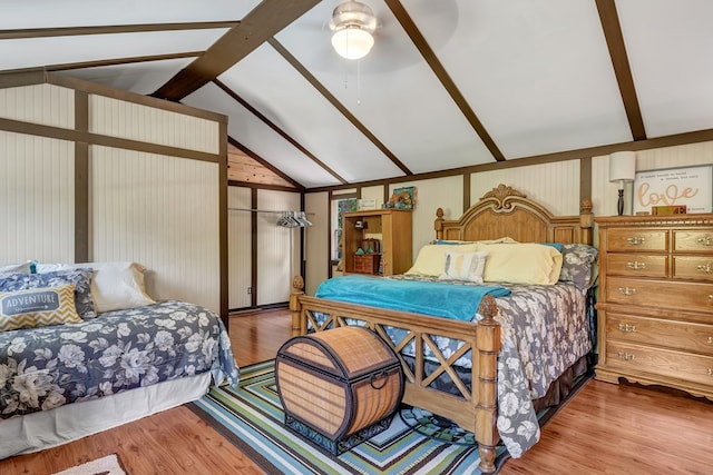 bedroom featuring lofted ceiling with beams and wood finished floors