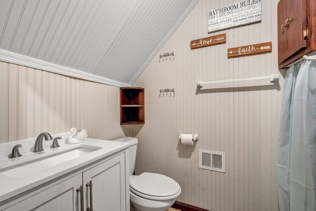 bathroom with lofted ceiling, visible vents, vanity, and toilet