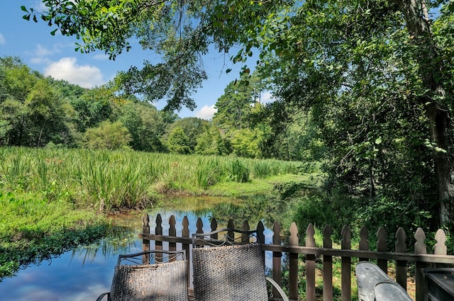 dock area featuring a water view and fence