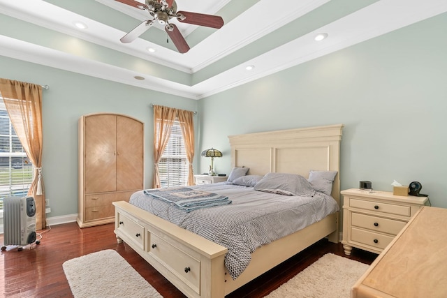 bedroom with baseboards, a raised ceiling, dark wood finished floors, ornamental molding, and recessed lighting