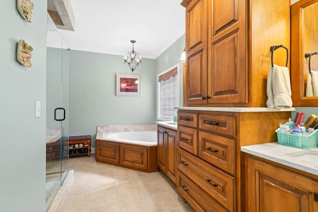 bathroom featuring an inviting chandelier, a stall shower, vanity, tile patterned flooring, and a bath