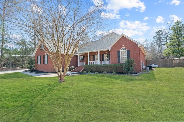 single story home featuring a porch, central air condition unit, brick siding, fence, and a front lawn