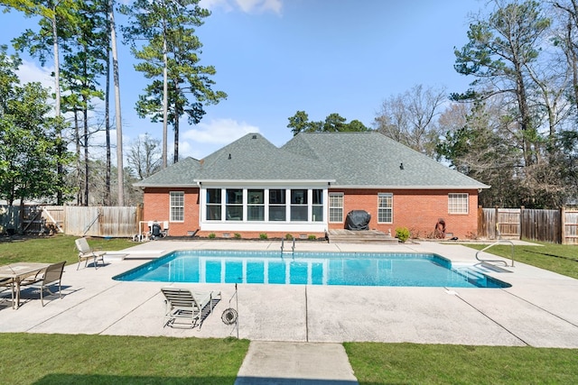 view of pool featuring a fenced in pool, a patio area, a lawn, and a fenced backyard