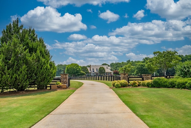 view of property's community with a lawn