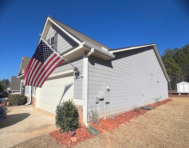 view of side of home featuring driveway and a garage