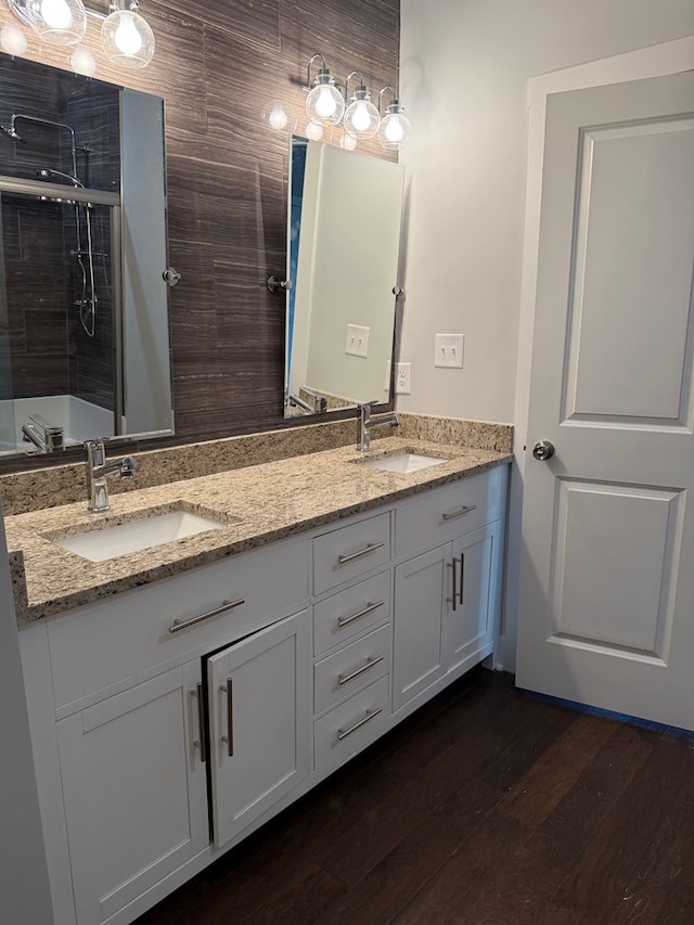 bathroom featuring a shower with door, vanity, and hardwood / wood-style floors