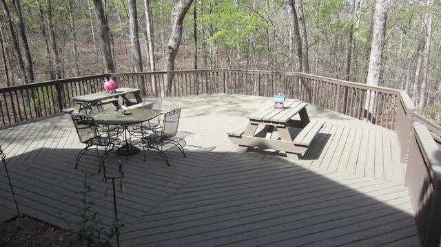 102 Treanor Dr, Milledgeville, GA 31061 - wooden terrace with outdoor dining area and a view of trees