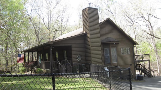 102 Treanor Dr, Milledgeville, GA 31061 - exterior space featuring a chimney, a fenced front yard, stairway, and central AC unit