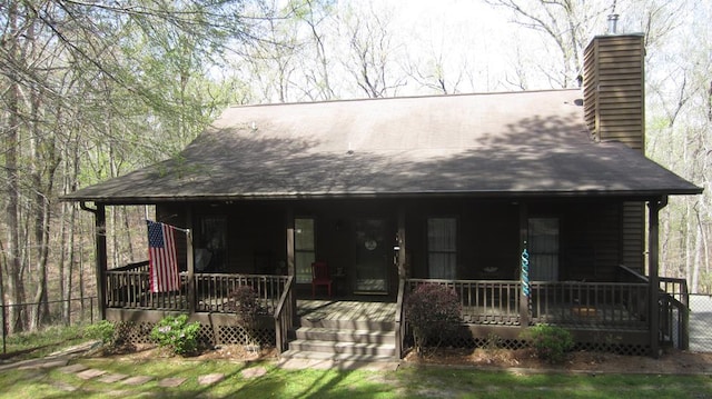 102 Treanor Dr, Milledgeville, GA 31061 - view of front facade with covered porch and a chimney