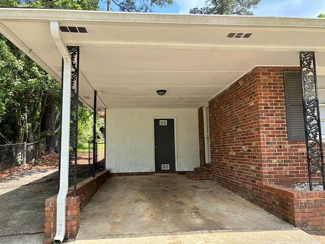 view of patio featuring fence, an attached carport, and entry steps