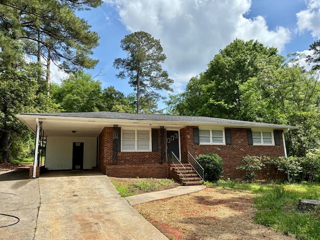ranch-style house featuring driveway, an attached carport, and brick siding