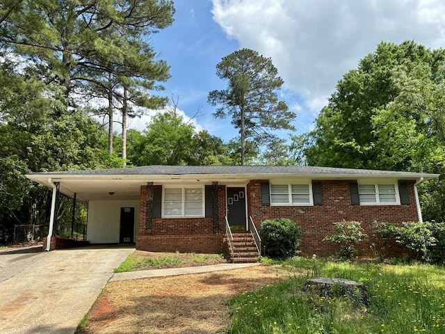 ranch-style house with driveway, a carport, and brick siding