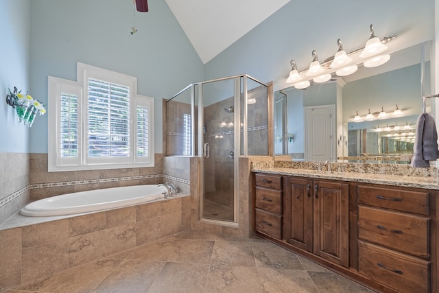 128A Montego Bay Rd, Milledgeville, GA 31061 - bathroom with vanity, a garden tub, a shower stall, high vaulted ceiling, and stone finish floors