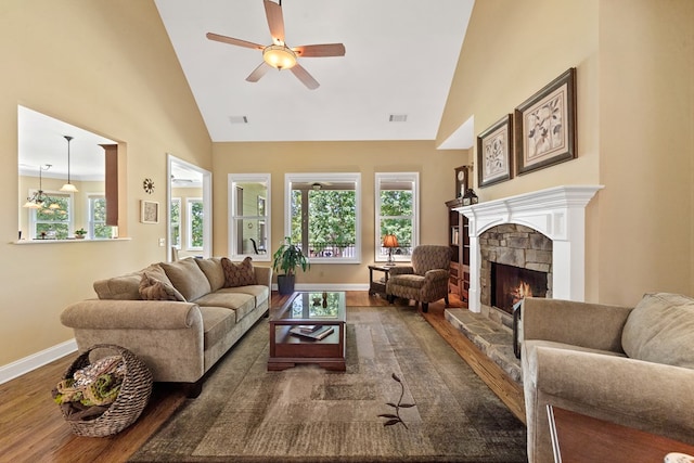 128A Montego Bay Rd, Milledgeville, GA 31061 - living area featuring dark wood finished floors, a fireplace, a ceiling fan, baseboards, and high vaulted ceiling
