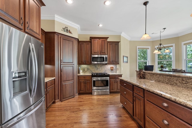 128A Montego Bay Rd, Milledgeville, GA 31061 - kitchen featuring stainless steel appliances, light wood-style flooring, decorative light fixtures, decorative backsplash, and crown molding