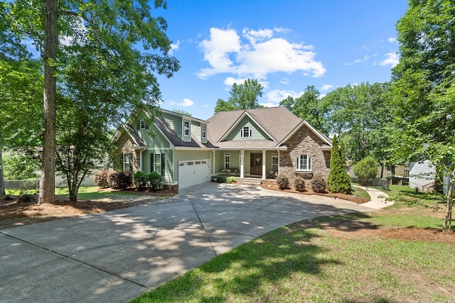 128A Montego Bay Rd, Milledgeville, GA 31061 - craftsman-style home with driveway, a porch, and stone siding