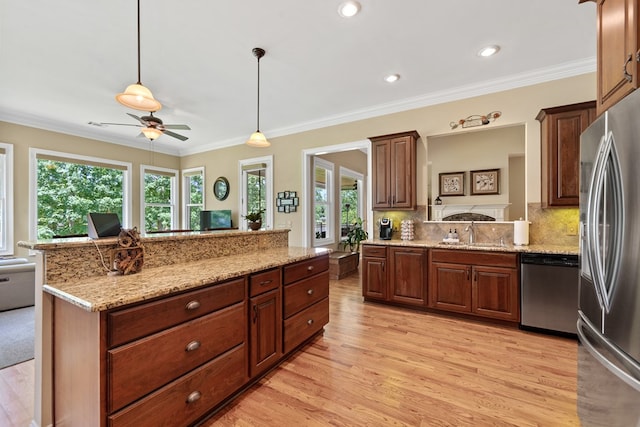 128A Montego Bay Rd, Milledgeville, GA 31061 - kitchen featuring stainless steel appliances, plenty of natural light, light wood-style floors, backsplash, and ornamental molding