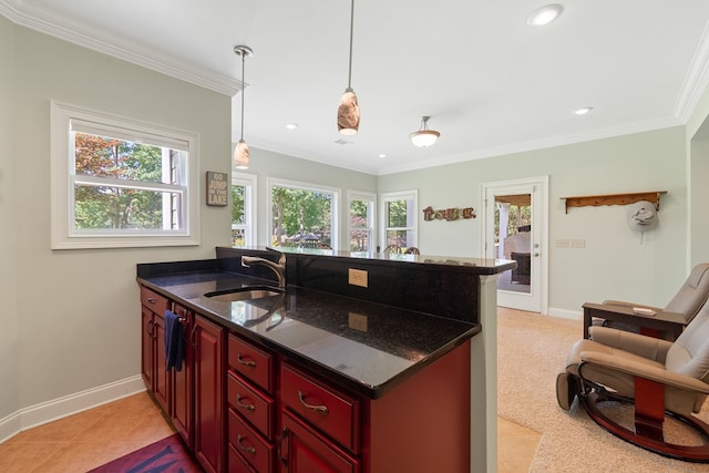 128A Montego Bay Rd, Milledgeville, GA 31061 - kitchen with a sink, reddish brown cabinets, a peninsula, baseboards, and ornamental molding