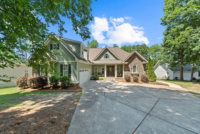 128A Montego Bay Rd, Milledgeville, GA 31061 - craftsman house featuring a porch, driveway, stone siding, and a garage