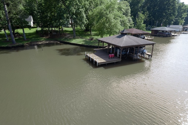 128A Montego Bay Rd, Milledgeville, GA 31061 - dock featuring a water view, boat lift, and view of wooded area