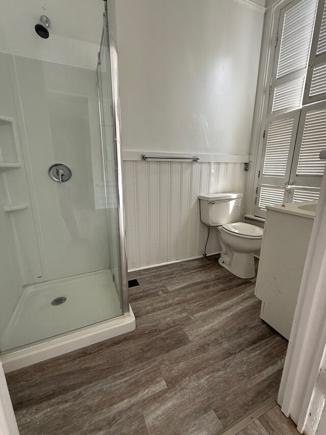120 Franklin St, Milledgeville, GA 31061 - bathroom with a stall shower, wainscoting, toilet, wood finished floors, and vanity