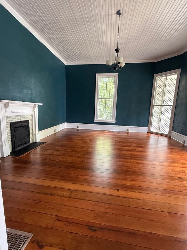 120 Franklin St, Milledgeville, GA 31061 - unfurnished living room featuring a chandelier, ornamental molding, a brick fireplace, and wood-type flooring