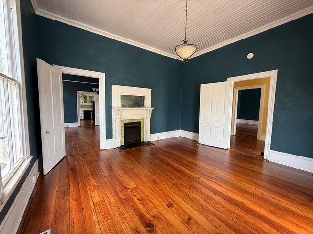 120 Franklin St, Milledgeville, GA 31061 - unfurnished living room featuring a brick fireplace, hardwood / wood-style flooring, crown molding, and baseboards