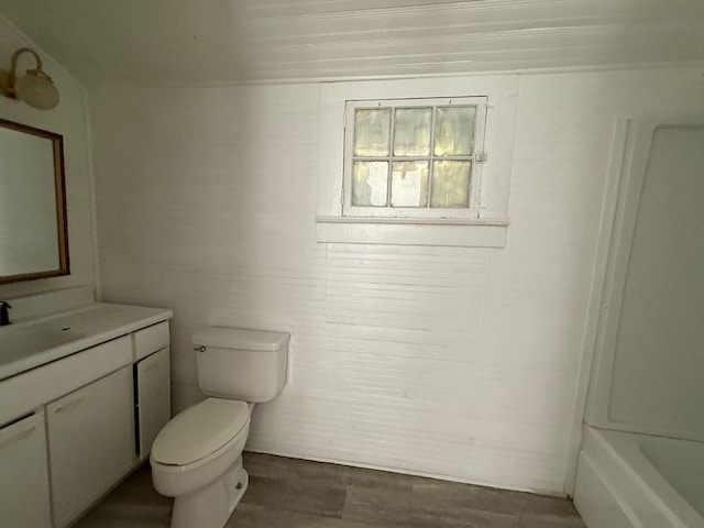 120 Franklin St, Milledgeville, GA 31061 - bathroom featuring toilet, vanity, a tub, wood finished floors, and a shower