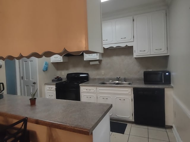 1745 Cedarwood Dr, Milledgeville, GA 31061 - kitchen featuring black appliances, a sink, a breakfast bar area, and white cabinetry