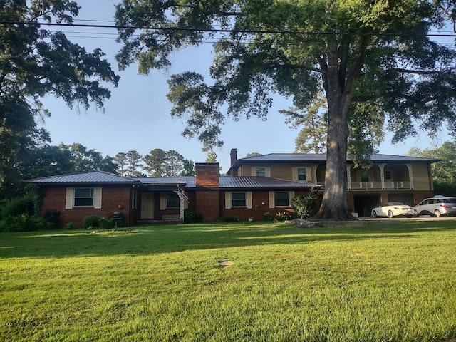 1745 Cedarwood Dr, Milledgeville, GA 31061 - ranch-style home with a chimney, a front yard, and metal roof