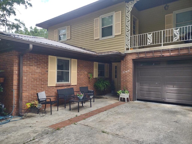 1745 Cedarwood Dr, Milledgeville, GA 31061 - view of patio / terrace featuring an attached garage, a balcony, and driveway