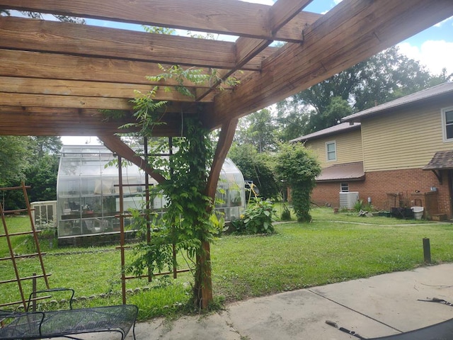 1745 Cedarwood Dr, Milledgeville, GA 31061 - view of grassy yard with a greenhouse, an outbuilding, a pergola, and cooling unit