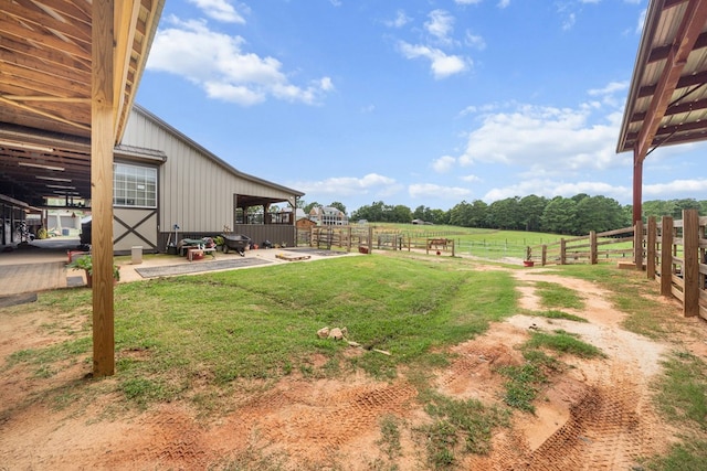 view of yard featuring a rural view and an outdoor structure