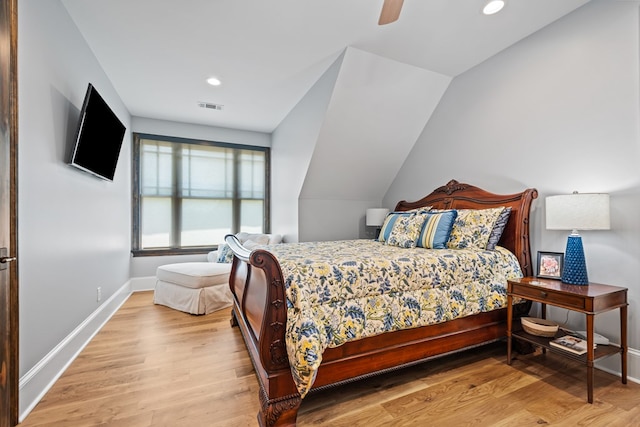 bedroom featuring ceiling fan, light hardwood / wood-style flooring, and vaulted ceiling