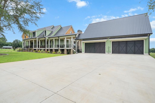 view of front of home with a garage, covered porch, and a front lawn