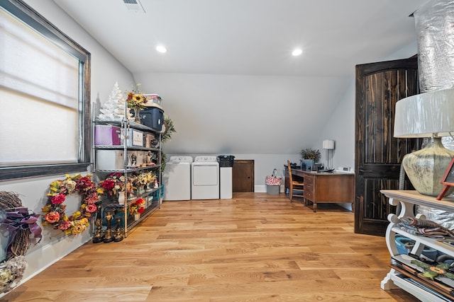 home office with washer and dryer, vaulted ceiling, and light wood-type flooring