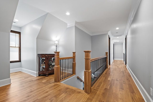 hall featuring crown molding and light hardwood / wood-style flooring