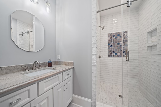 bathroom featuring vanity and an enclosed shower