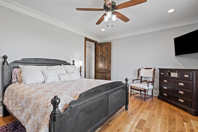 bedroom with light hardwood / wood-style floors, ceiling fan, and ornamental molding