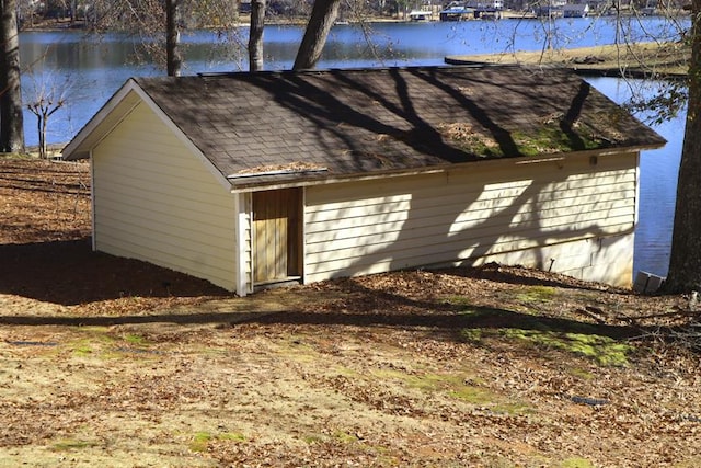 exterior space featuring a water view and an outdoor structure