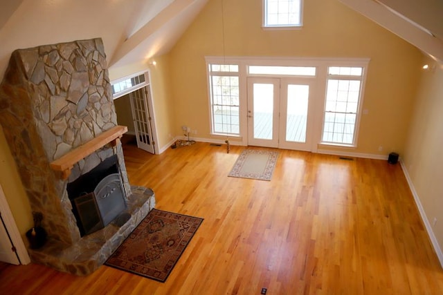 interior space featuring lofted ceiling, baseboards, and wood finished floors