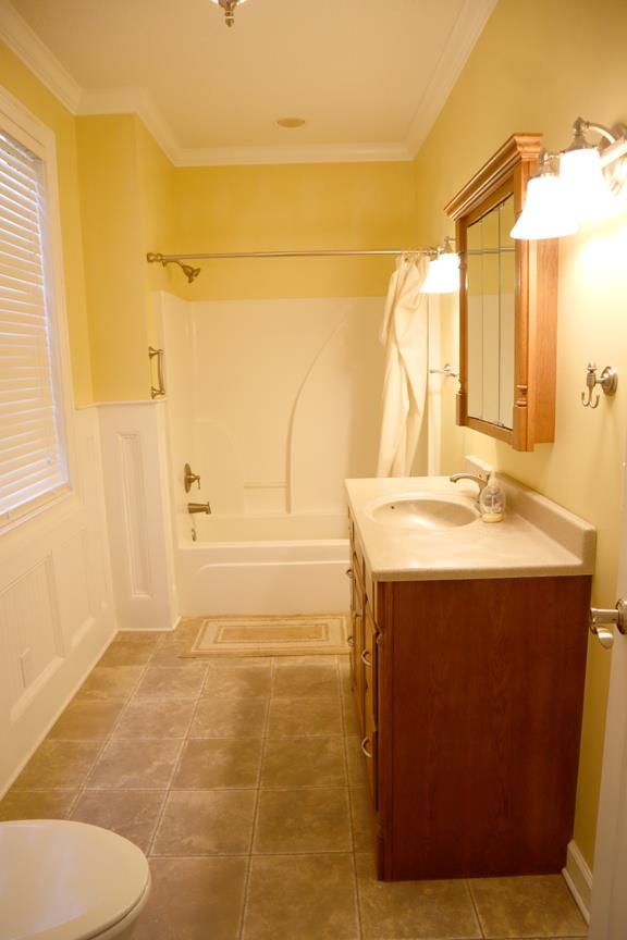 bathroom with toilet, bathtub / shower combination, ornamental molding, and vanity