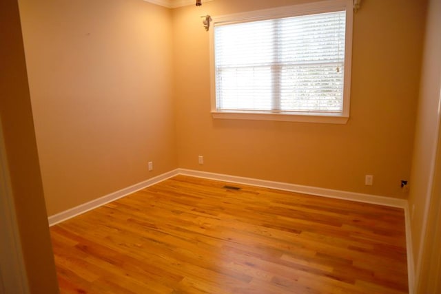 empty room with wood finished floors and baseboards