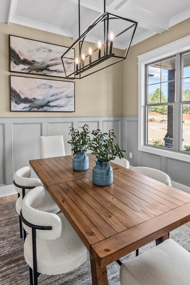 dining area featuring beamed ceiling and ornamental molding