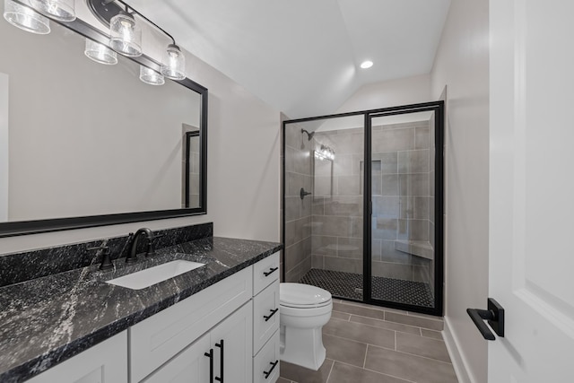 bathroom with tile patterned flooring, vanity, toilet, and a shower with door